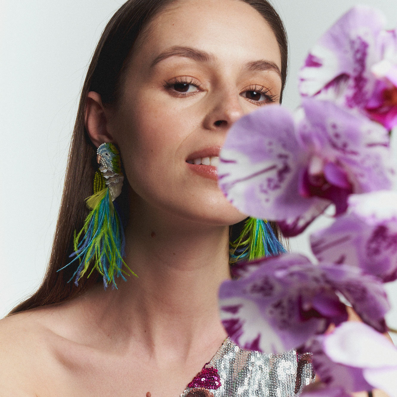 Blue, Green, and White Beaded and Feather Embroidered Bird Stud Earrings Styled on Model