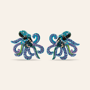 Blue, Purple, and Green Beaded Octopus Earrings on Tan Background