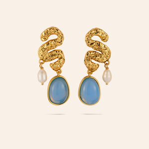 Blue Stone, Pearl, and Gold Squiggle Drop Earrings on Tan Background