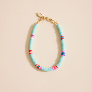 Turquoise and Multi Rubber Beaded Anklet with Gold Chain on Tan Background