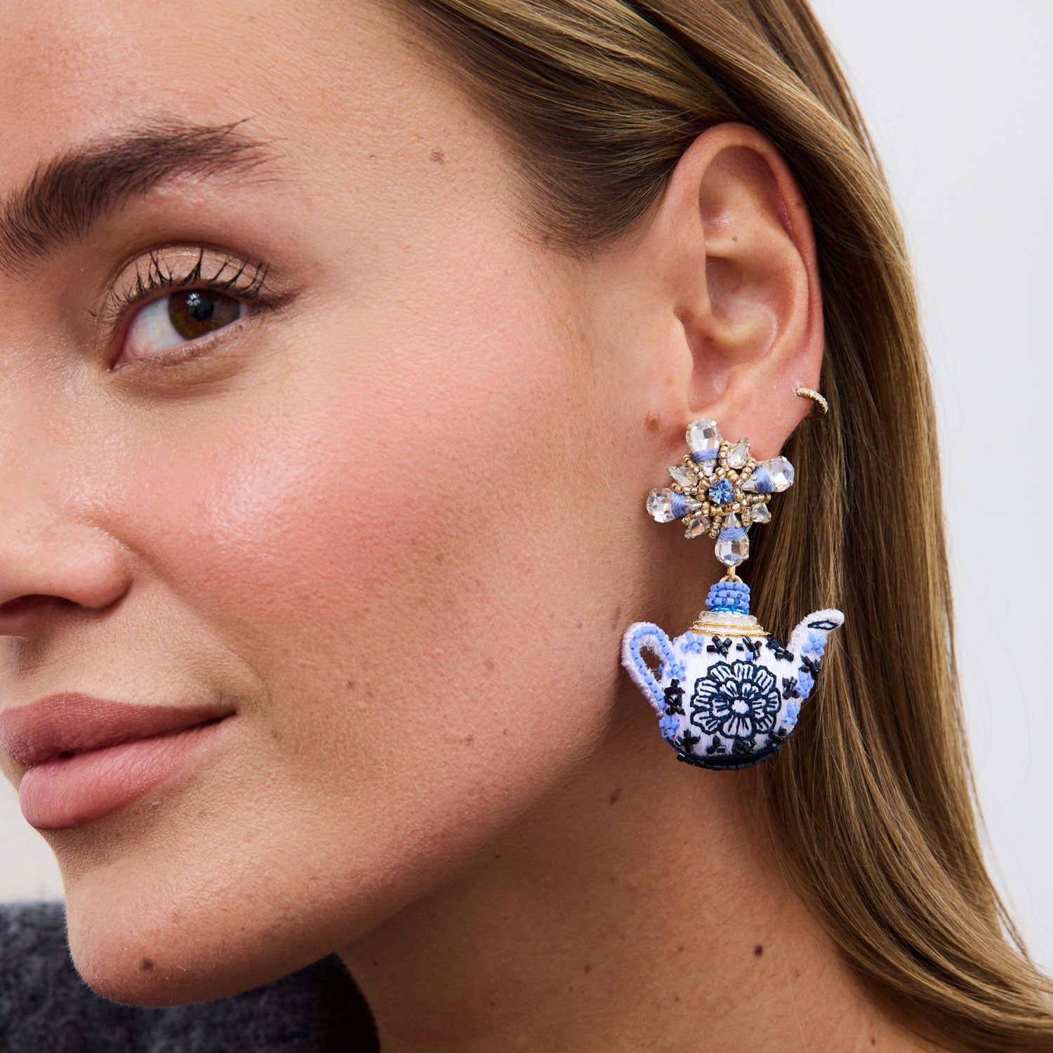 model wearing blue and white teapot drop earrings