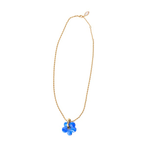 Blue and White Marbled Glass Flower Charm on Gold Chain On Flat White Background
