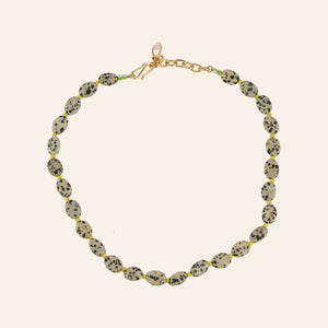 Brown and Black Stone and Yellow Bead Strand Necklace on Tan Background