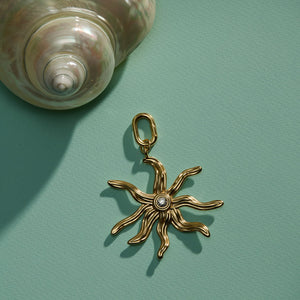Wavy Gold and Crystal Charm Staged with Shell on Green Surface