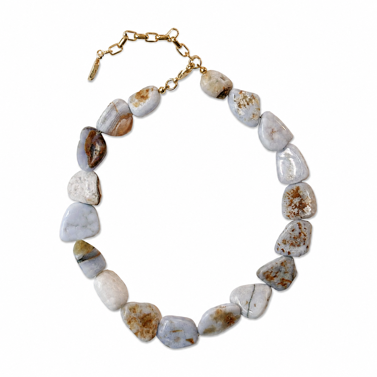A tumbled stone necklace made of irregular, polished pebble-shaped beads in shades of gray, beige, and white with natural brown matrix patterns, finished with a gold-tone clasp.