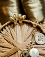 Gold hoop earrings and gold chain necklace on basket