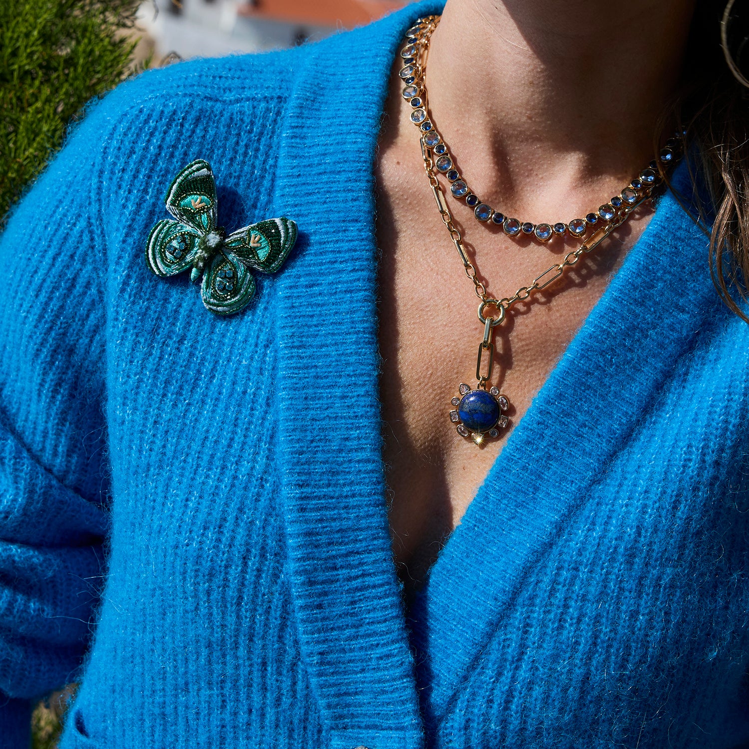Green Butterfly Beaded and Embroidered Brooch on Mignonne Gavigan styled on a blue cardigan