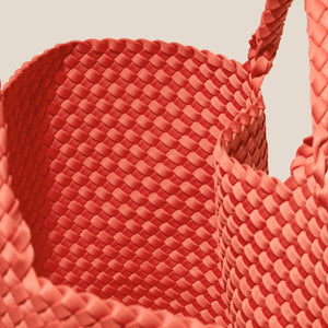 Coral Woven Neoprene Bag Up Close On Flat Cream Background