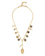 Gold charm necklace against a white background