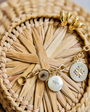 Gold chain necklace and hoop earrings on basket