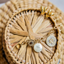 Gold chain necklace and hoop earrings on basket