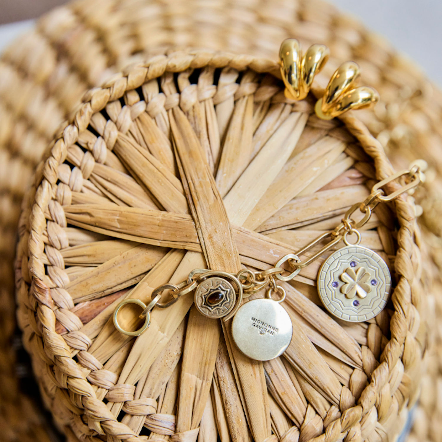 Gold chain necklace and hoop earrings on basket