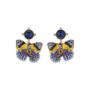 A pair of butterfly-shaped stud earrings with blue oval stones at the top and wings in yellow, purple, and blue enamel on a white background.