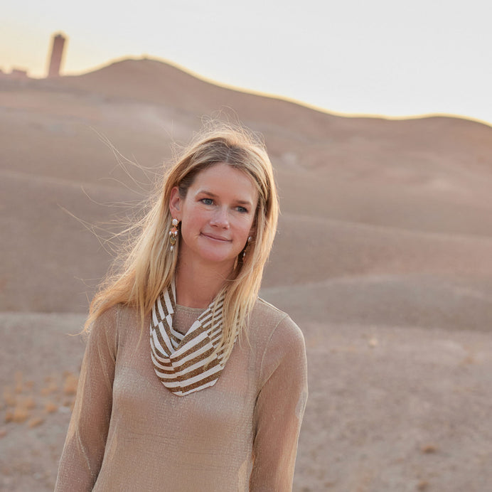 Patterned Ivory and Bronze Beaded Scarf Necklace on Maggie in Tan Dress in Desert