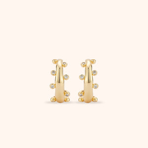 Crystal and Gold Hoop Earrings on Tan Background