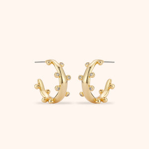 Crystal and Gold Hoop Earrings on Tan Background