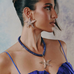 Crystal Starfish Earrings Styled on Model in Blue Beaded Necklace with Crystal Starfish Charm and Blue Top