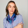 Blue patterned, beaded and embroidered scarf necklace featuring colorful pink and purple details on model