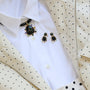 Semi Precious Black Onyx, Statement Earrings with Green and Blue Cubic Zirconia embellished drop dangle statement earrings with gold hardware Styled on a Flat lay