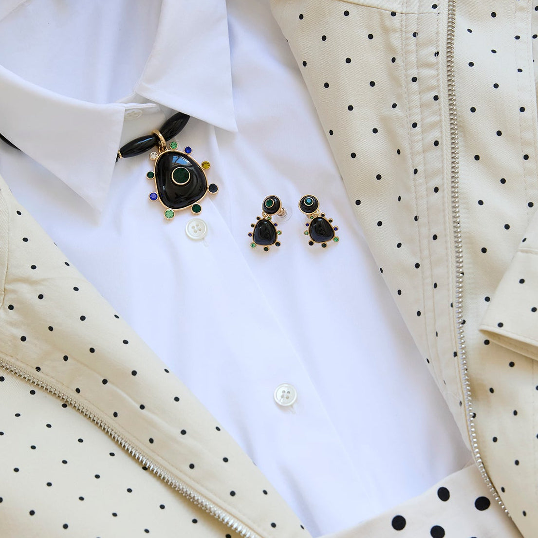 Semi Precious Black Onyx, Statement Earrings with Green and Blue Cubic Zirconia embellished drop dangle statement earrings with gold hardware Styled on a Flat lay