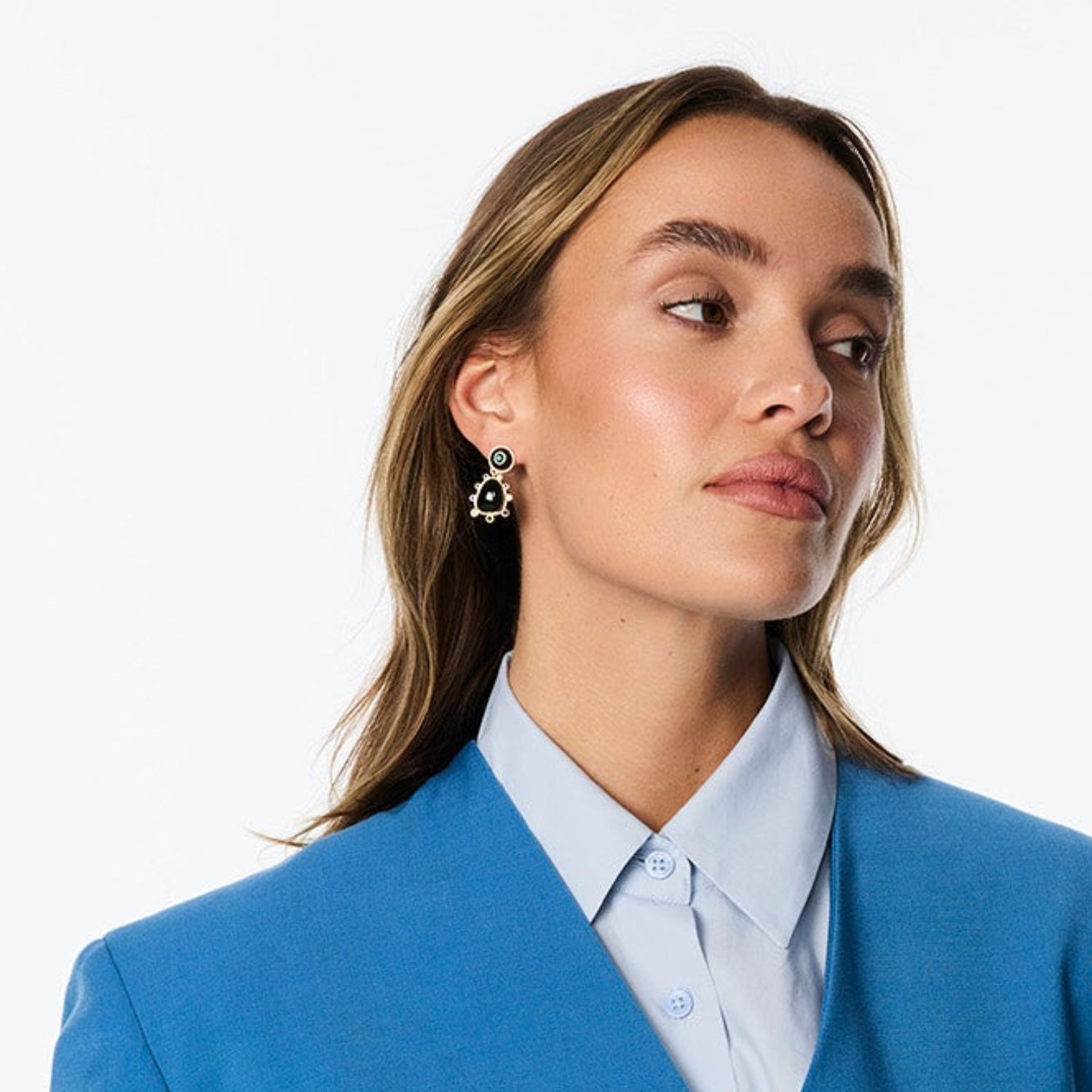Semi Precious Black Onyx, Statement Earrings with Green and Blue Cubic Zirconia embellished drop dangle statement earrings with gold hardware on model