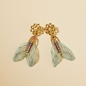 Embroidered Light Blue Moth Drop Earrings on Cream Background