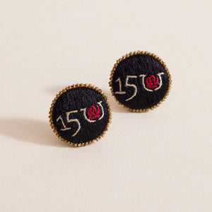 Black Embroidered Stud Earrings with Gold Beads on Cream Background