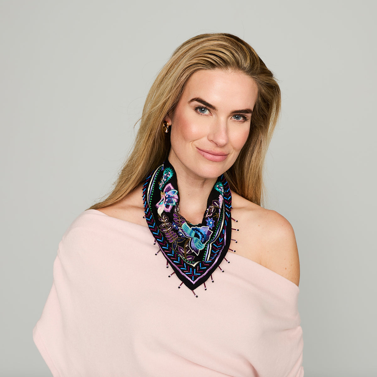 Black scarf necklace featuring colorful floral and geometric embroidery with beaded details on model
