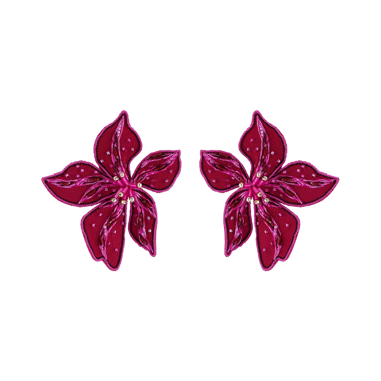 Magenta flower-shaped statement earrings featuring layered petals and intricate beadwork on white