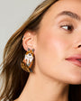 Model wearing fox embroidered and beaded earrings against a white background