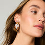 Model wearing fox embroidered and beaded earrings against a white background