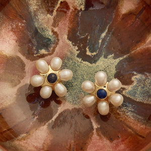 Pearl, Blue Stone, and Gold Stud Earrings Styled on Patterned Bowl