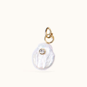 Freshwater Pearl, Crystal, and Gold Charm on Tan Background