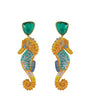 Seahorse shaped earrings with green stones on white background