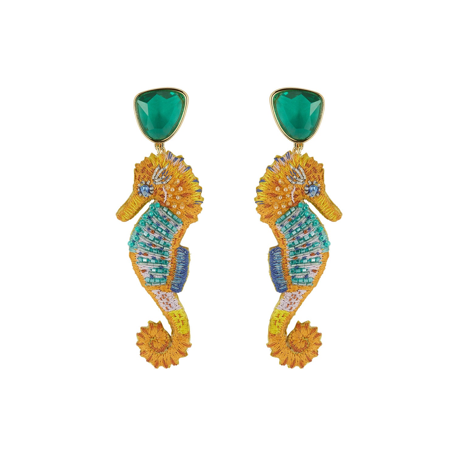 Seahorse shaped earrings with green stones on white background
