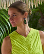Model Wearing Leslie Earrings against dark background in yellow dress. 