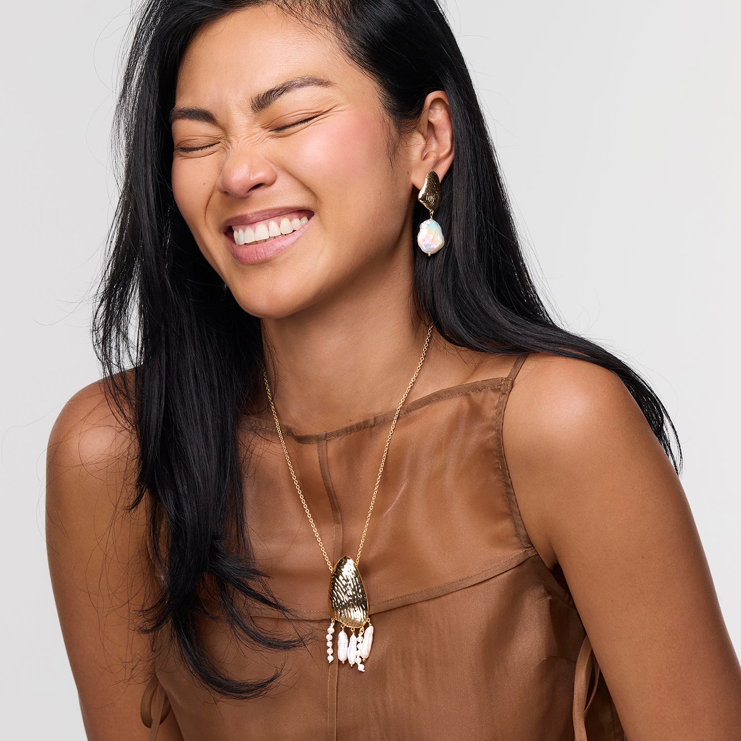 Model wearing Gloria Drop Earrings and Gloria Necklace