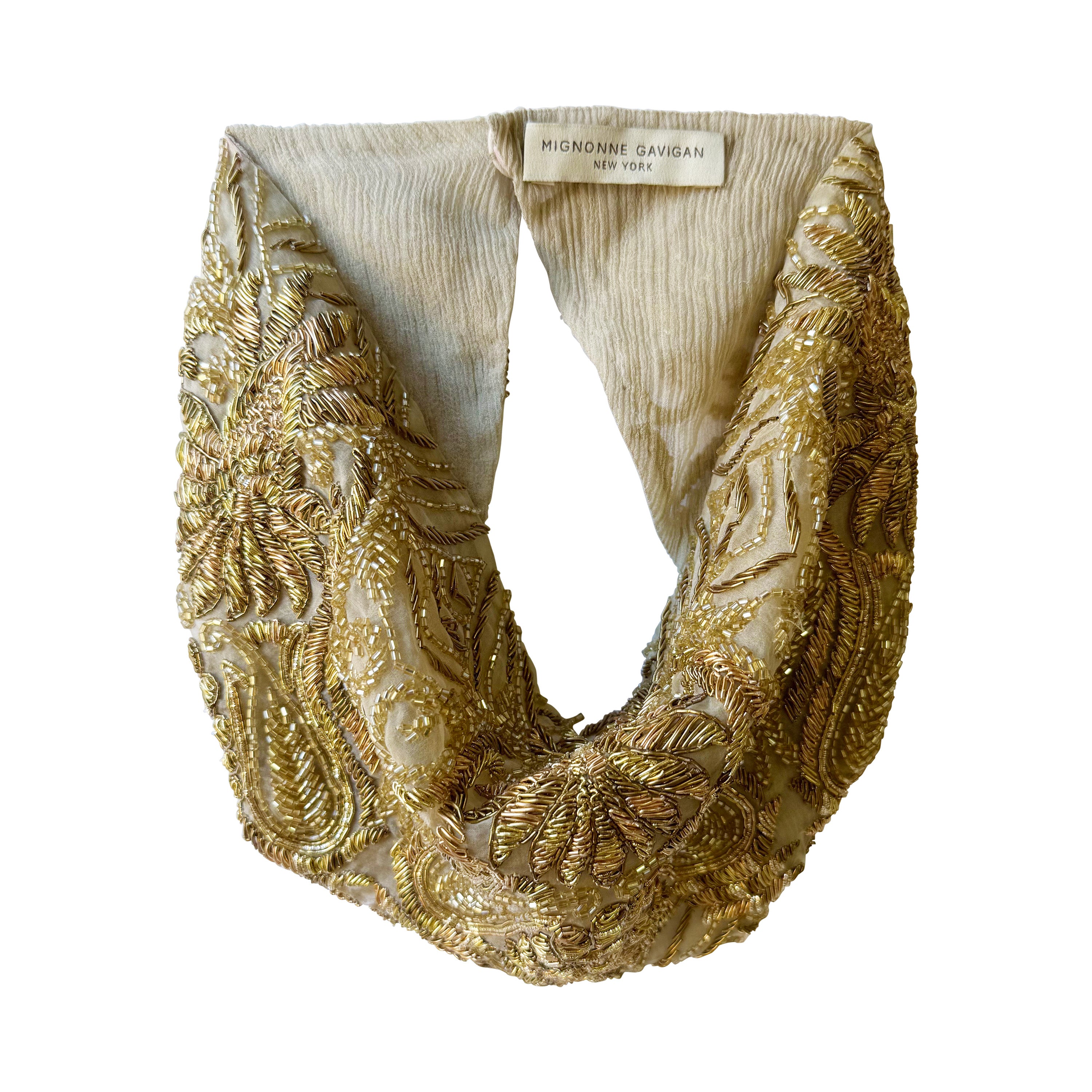Gold embroidered scarf with a visible brand label on a white background