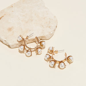 Pearl and Gold Hoop Earrings Staged on Cream Background with Stone