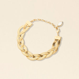 Gold Braided Herringbone Bracelet on Tan Background