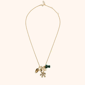 Gold, Stone, and Crystal Pendant Charm Necklace on Flat Tan Background