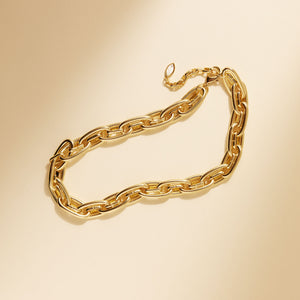 Gold Chain Necklace on Cream Background