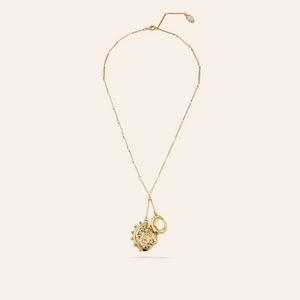 Gold Charm Pendant Necklace on Tan Background