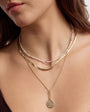 Gold Compass Pendant Necklace, Gold Herringbone Necklace, and Blush Pearl Necklace Styled on Model