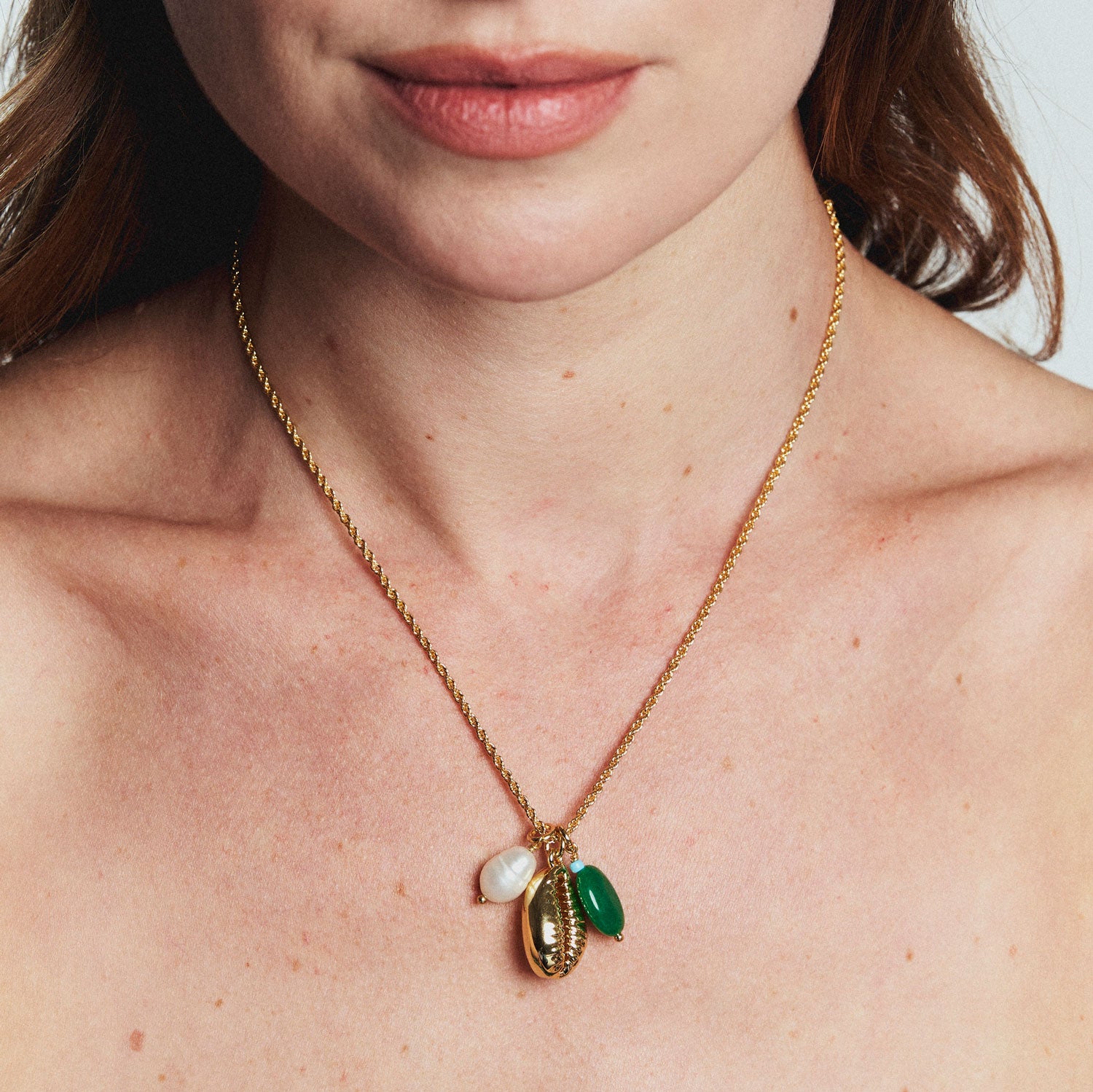 Freshwater Pearl, Gold Cowrie Shell, and Green Stone Pendant Charm Necklace Styled on Model