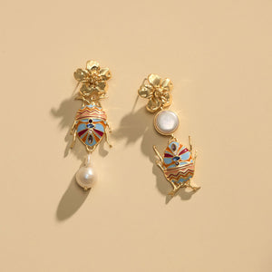 Pearl Enamel and Gold Drop Earrings Staged on Cream Background