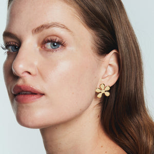 Gold Flower Stud Earrings Styled on Model