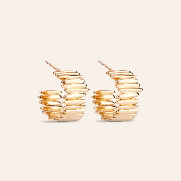 Gold Hoop Earrings on Cream Background