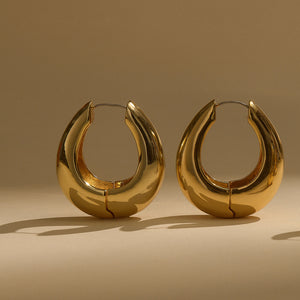 Gold Hoops Earrings with Shadow on Flat Background