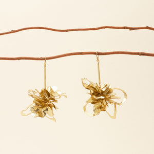 Gold Sequin Drop Earrings Staged on Branches with Cream Background